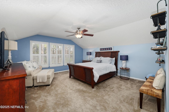 bedroom featuring light carpet, ceiling fan, vaulted ceiling, and a textured ceiling