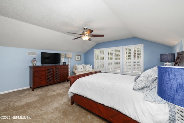 carpeted bedroom featuring ceiling fan, lofted ceiling, and a textured ceiling