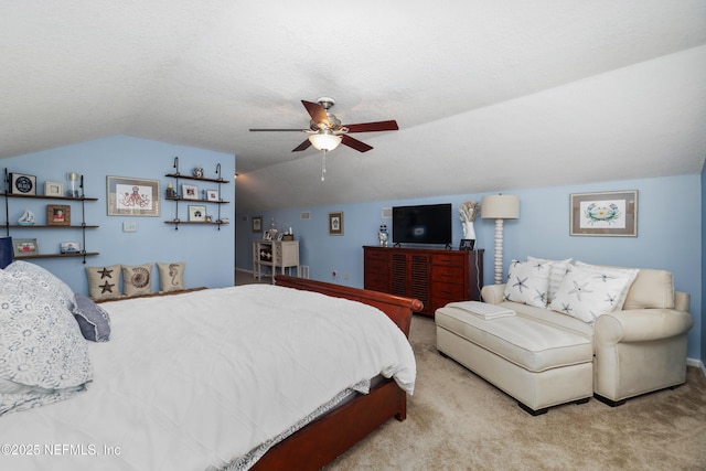 carpeted bedroom featuring a textured ceiling, vaulted ceiling, and ceiling fan