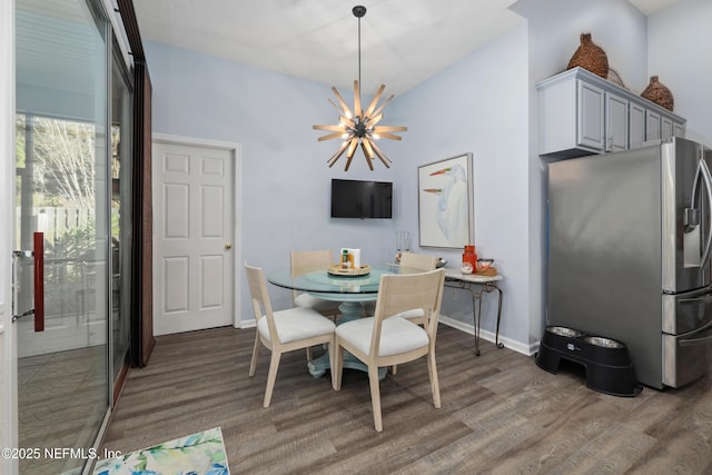 dining room featuring a notable chandelier and dark hardwood / wood-style floors