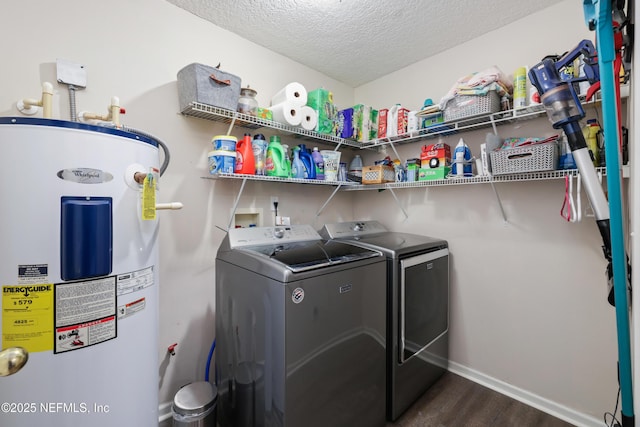 clothes washing area featuring separate washer and dryer, dark wood-type flooring, electric water heater, and a textured ceiling