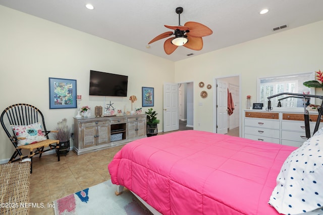 tiled bedroom featuring ceiling fan