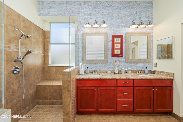 bathroom featuring tiled shower and vanity