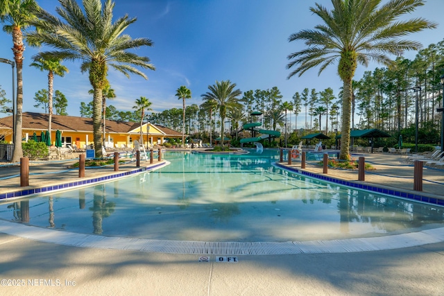 view of pool with a patio area and a water slide