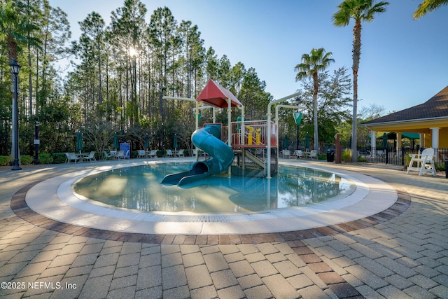 view of pool with a playground