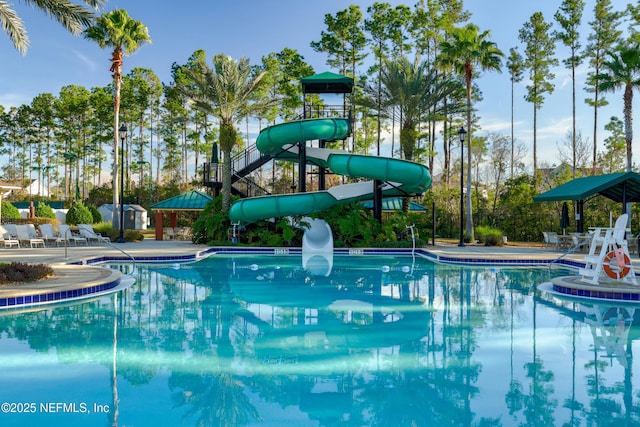 view of pool featuring a patio area and a water slide