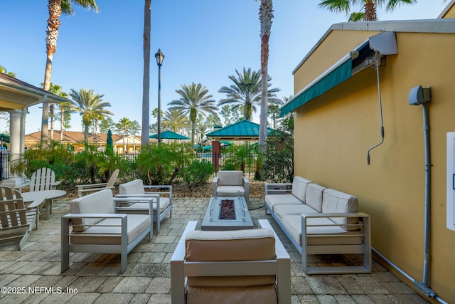 view of patio / terrace featuring an outdoor living space with a fire pit