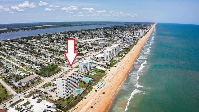 drone / aerial view with a water view and a beach view