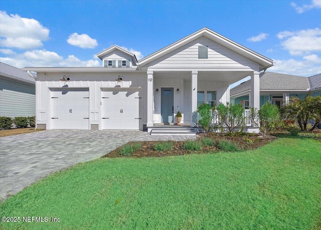 view of front facade with a garage, covered porch, and a front lawn