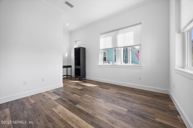 unfurnished living room with crown molding, a healthy amount of sunlight, and dark hardwood / wood-style floors