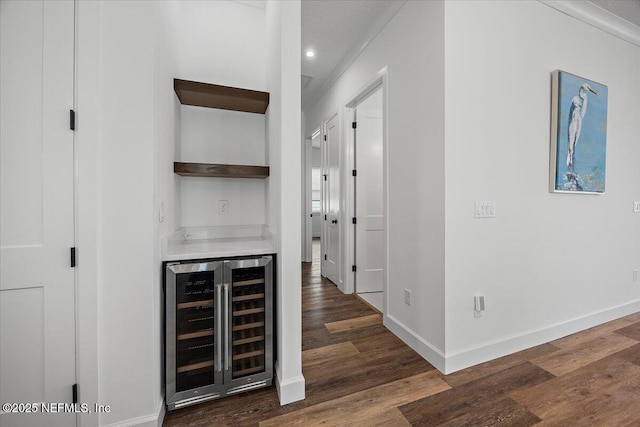 bar with wine cooler and dark hardwood / wood-style floors