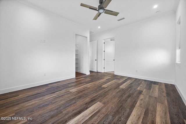 spare room featuring dark hardwood / wood-style flooring, ornamental molding, and ceiling fan