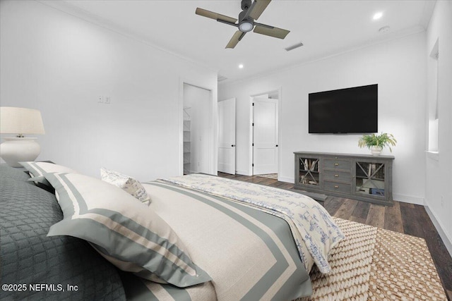 bedroom with crown molding, ceiling fan, and dark hardwood / wood-style flooring