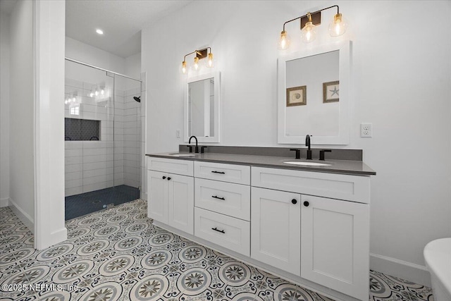 bathroom with tile patterned floors, vanity, and a tile shower