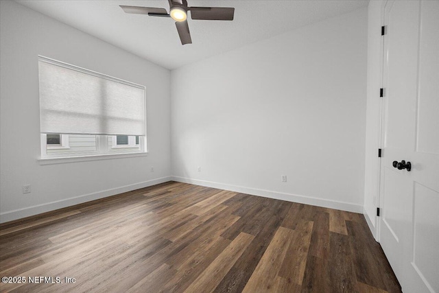 empty room featuring dark hardwood / wood-style flooring and ceiling fan