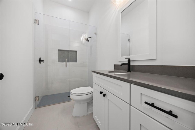 bathroom featuring vanity, walk in shower, tile patterned floors, and toilet