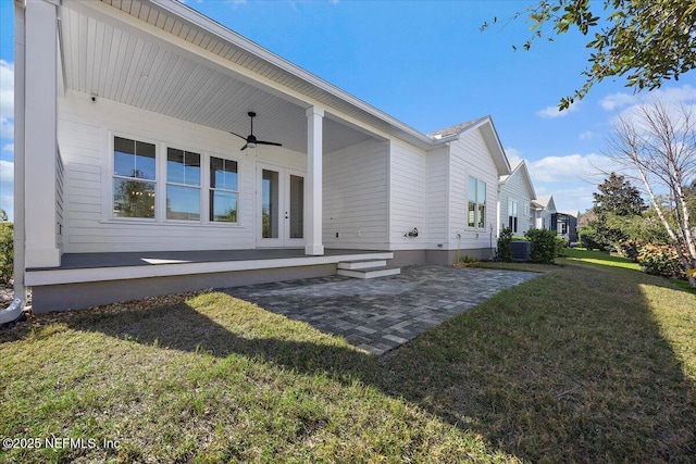 back of house featuring a patio area, ceiling fan, and a lawn