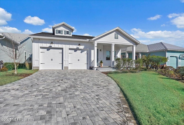 view of front of home with a garage, a front lawn, and covered porch