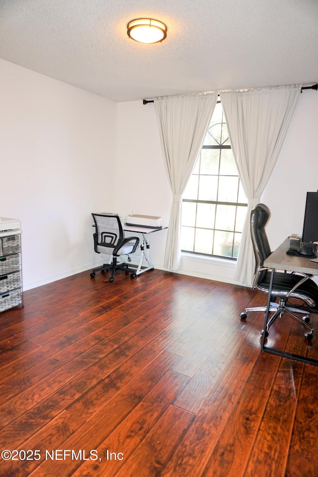 home office featuring hardwood / wood-style floors and a textured ceiling