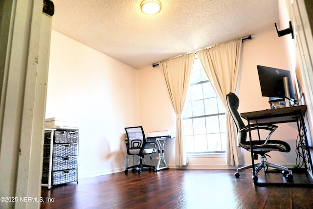 office featuring dark wood-type flooring and a textured ceiling