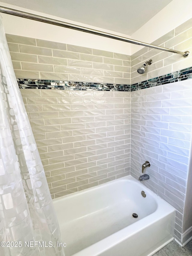 bathroom featuring shower / bath combo with shower curtain