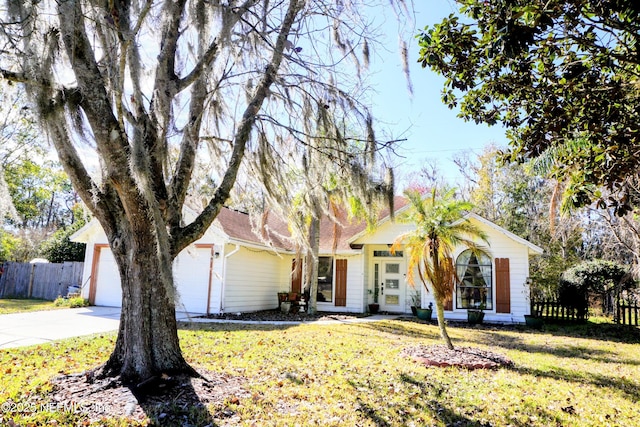 ranch-style home featuring a garage and a front yard