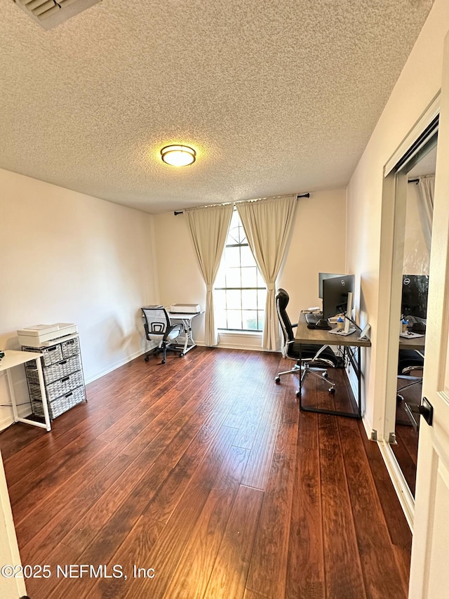 office space featuring wood-type flooring and a textured ceiling