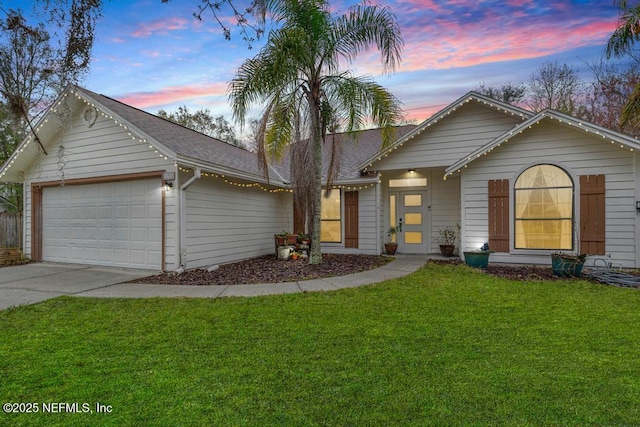 ranch-style home featuring a garage, roof with shingles, a lawn, and concrete driveway