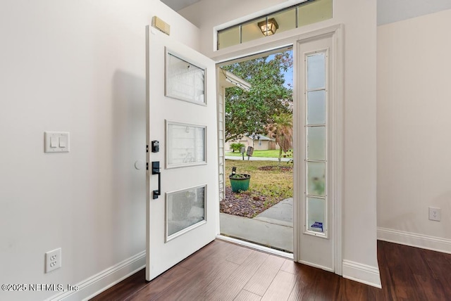 foyer entrance featuring dark wood-type flooring and baseboards