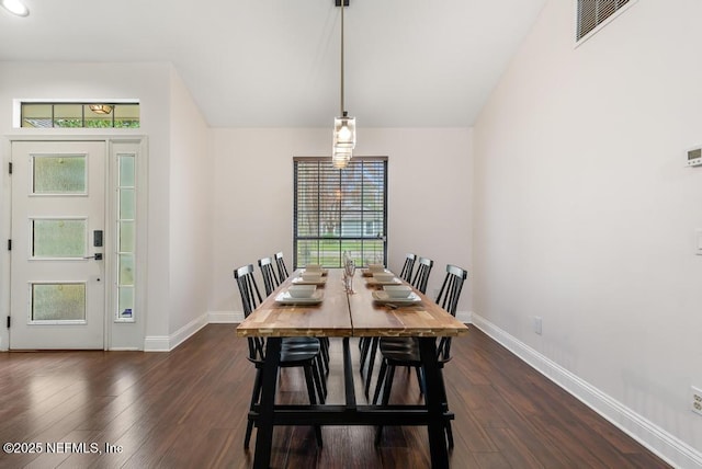 dining space with dark wood finished floors, visible vents, plenty of natural light, and baseboards