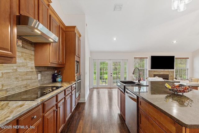 kitchen with french doors, visible vents, appliances with stainless steel finishes, brown cabinetry, and under cabinet range hood