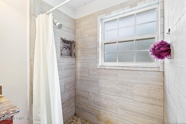 full bathroom with a tile shower