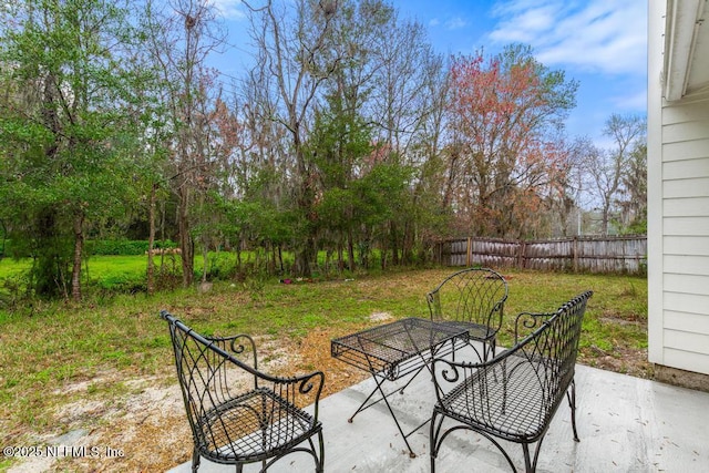 view of patio featuring fence