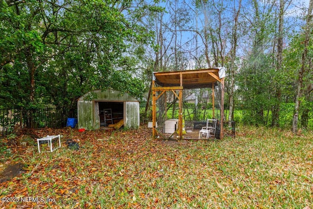 view of yard with an outdoor structure and fence