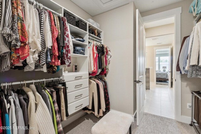 spacious closet featuring light tile patterned floors