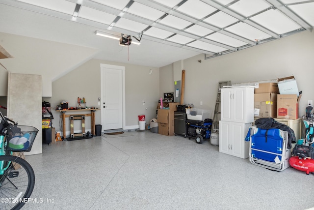 garage with a garage door opener and electric panel