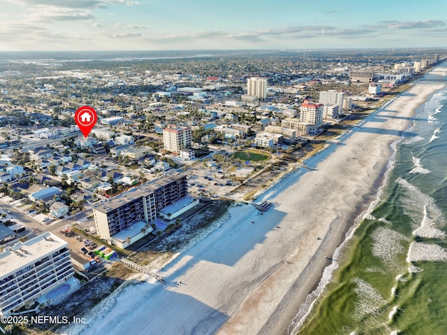 aerial view with a water view and a beach view