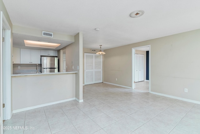 unfurnished living room with light tile patterned flooring