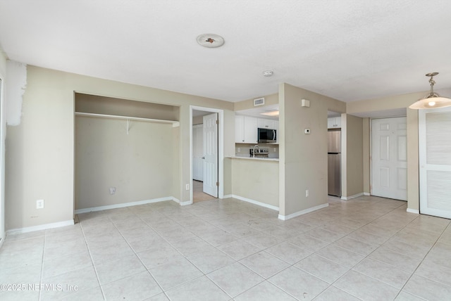 unfurnished living room with light tile patterned floors