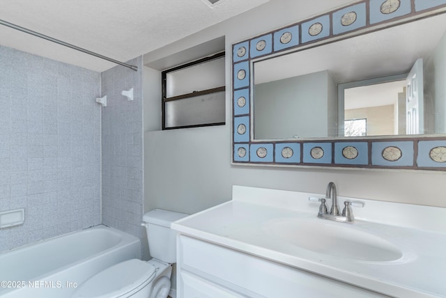 full bathroom featuring tiled shower / bath, vanity, a textured ceiling, and toilet