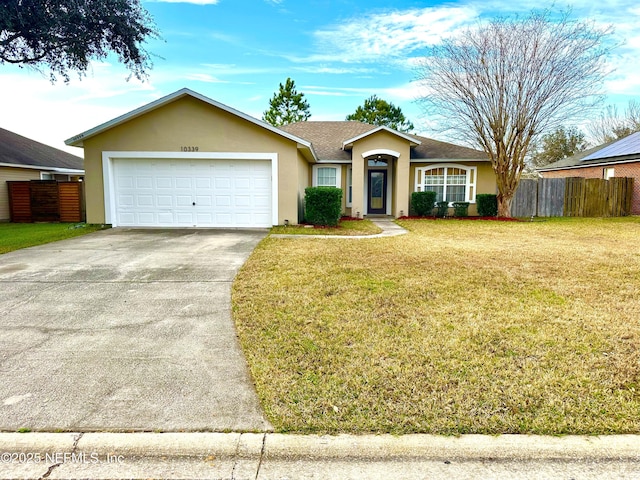 single story home featuring a garage and a front lawn