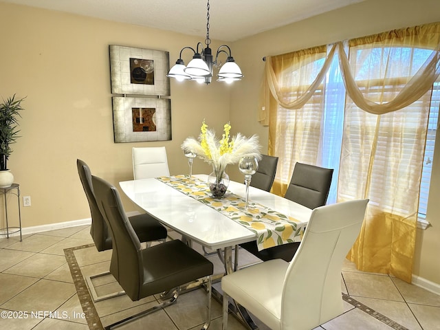 dining room featuring light tile patterned floors and a notable chandelier