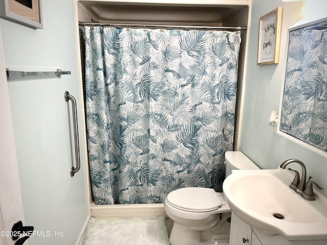 bathroom with vanity, toilet, and walk in shower