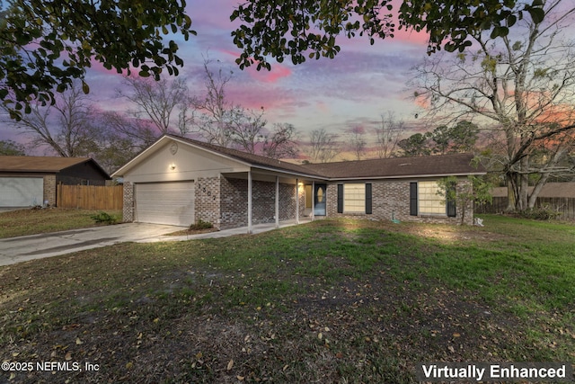 single story home with a garage and a lawn