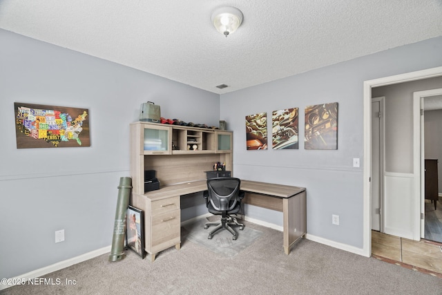 office area with light carpet and a textured ceiling