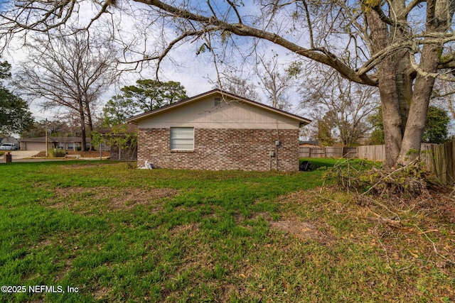 view of side of property featuring a yard