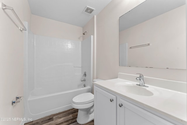 full bathroom featuring vanity, shower / bathing tub combination, hardwood / wood-style floors, and toilet