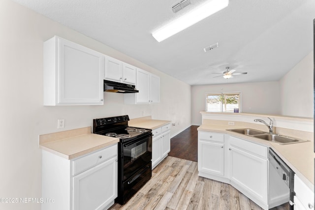 kitchen featuring white dishwasher, black electric range oven, sink, and white cabinets