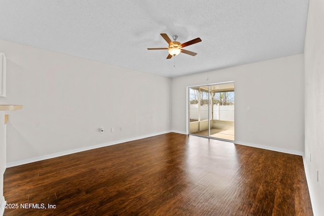 spare room featuring ceiling fan, a textured ceiling, and dark hardwood / wood-style flooring