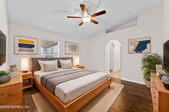 bedroom with lofted ceiling, ceiling fan, dark hardwood / wood-style floors, and a textured ceiling